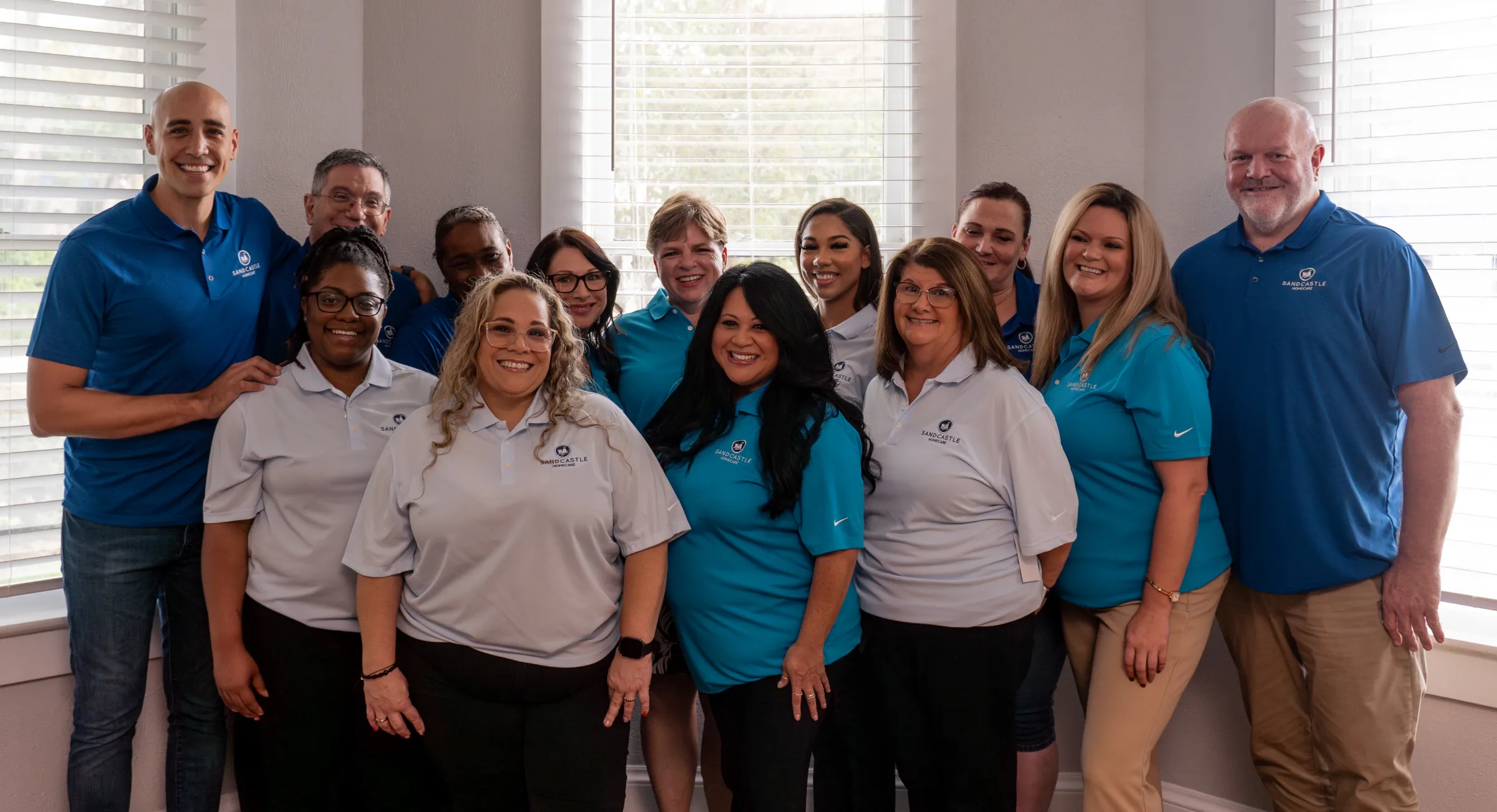 The Sandcastle Homecare team in uniform, smiling together